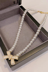 Bow Necklace With Pearl Input: Blue Striped T-Shirt Output: In Leather Wallet Coin Pocket Floral
